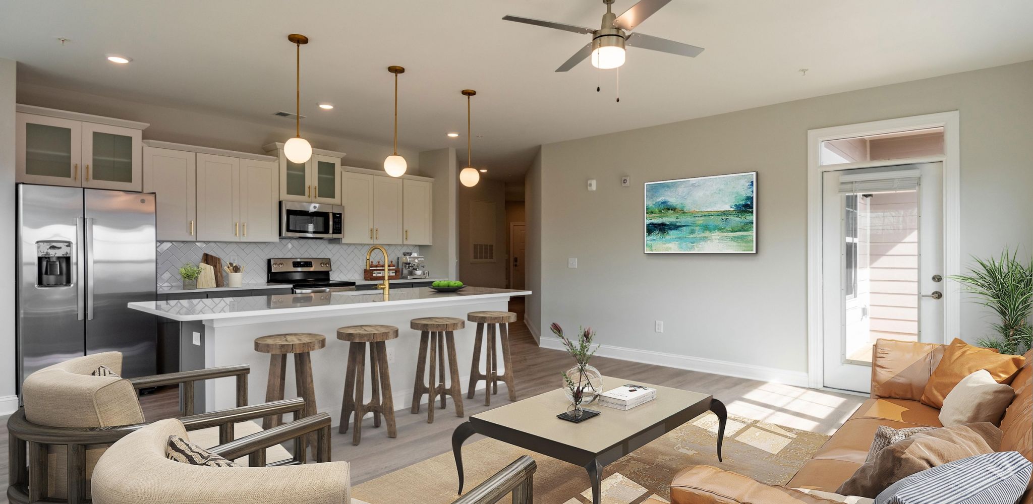 Hawthorne at Haywood apartment kitchen and living area with quartz countertops, stainless steel appliances, and ample cabinet storage