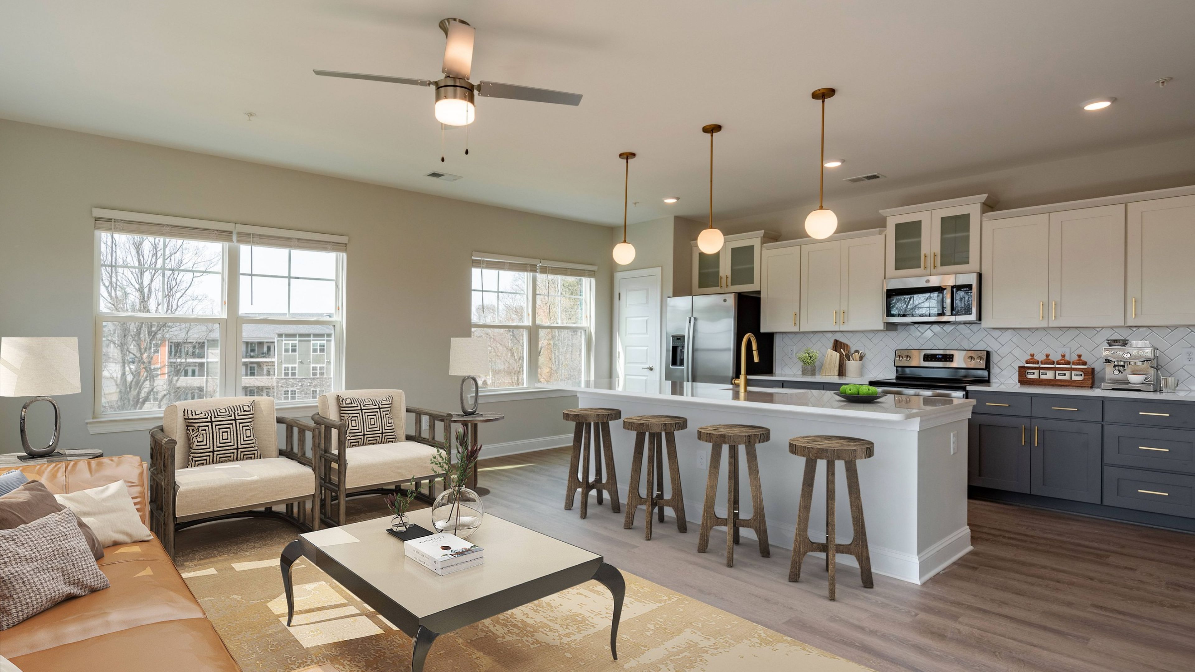 Hawthorne at Haywood apartment kitchen and living area with quartz countertops, stainless steel appliances, and ample cabinet storage