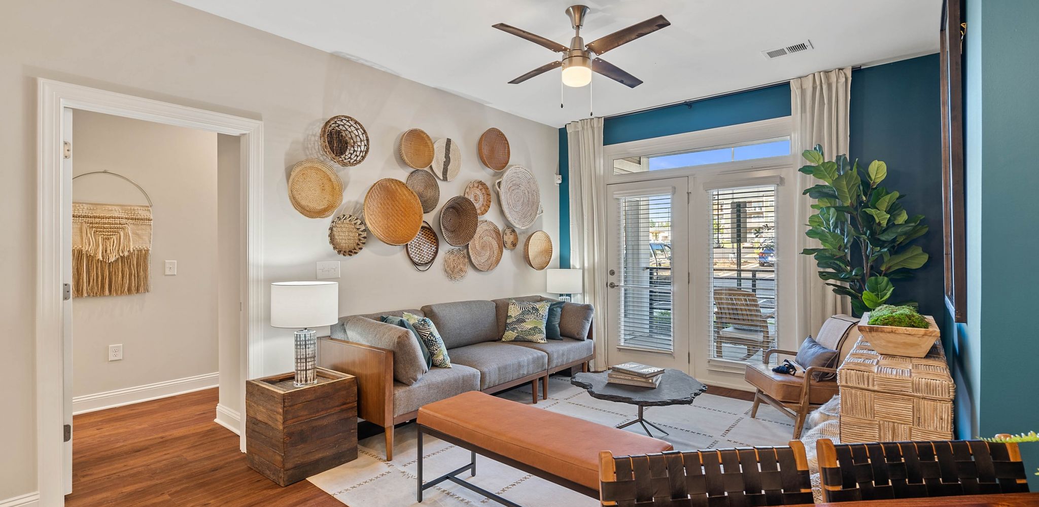 Hawthorne at Haywood apartment living room with large patio doors, furnished with a couch, coffee table, and chair