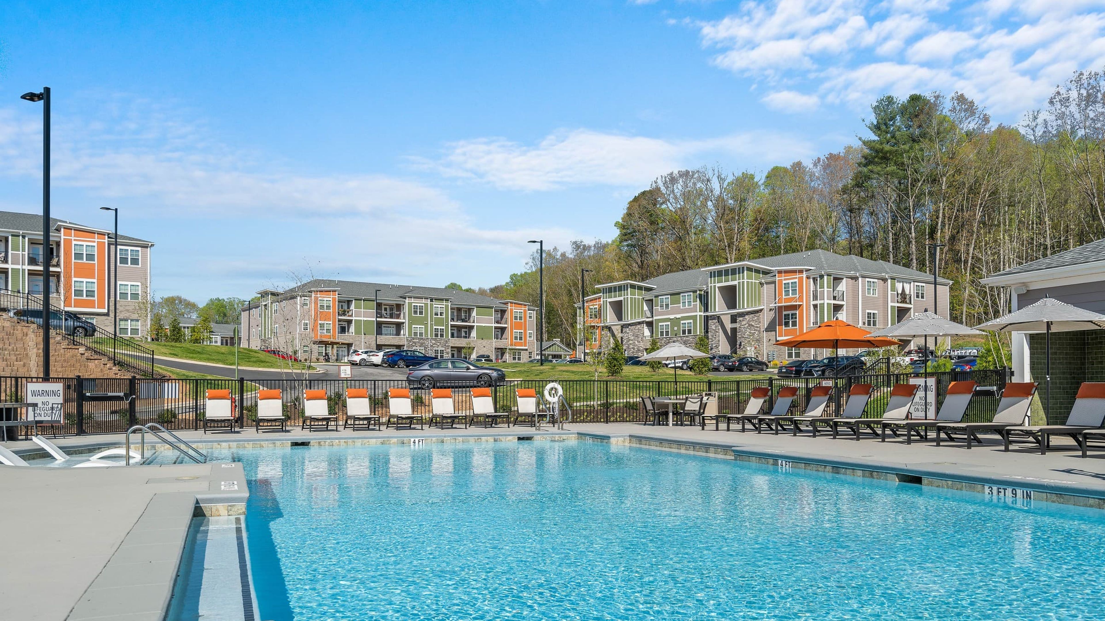 Hawthorne at Haywood luxury outdoor pool with in-pool lounge chairs and surrounding seating